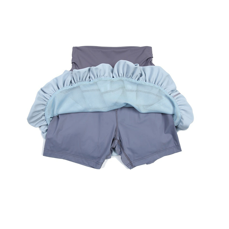 Back view of a pale blue bubble tennis skirt folded up to show the slate-purple built-in shorts.