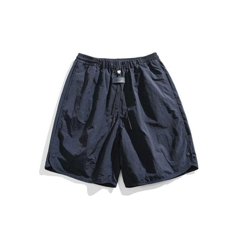Navy knee-length shorts with elastic drawcord waist, toggle and curved side hems, flat lay front view
