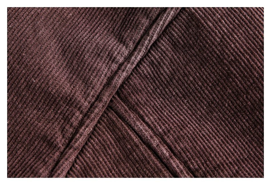 Close-up of dark brown ribbed fabric with overlapping seams.