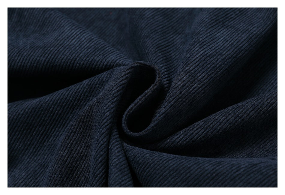Close-up of dark navy ribbed fabric gathered into soft folds.