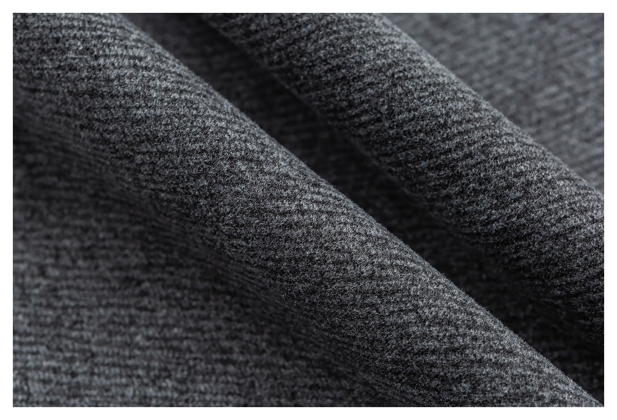 Macro view of the textured heather gray fabric on the joggers.