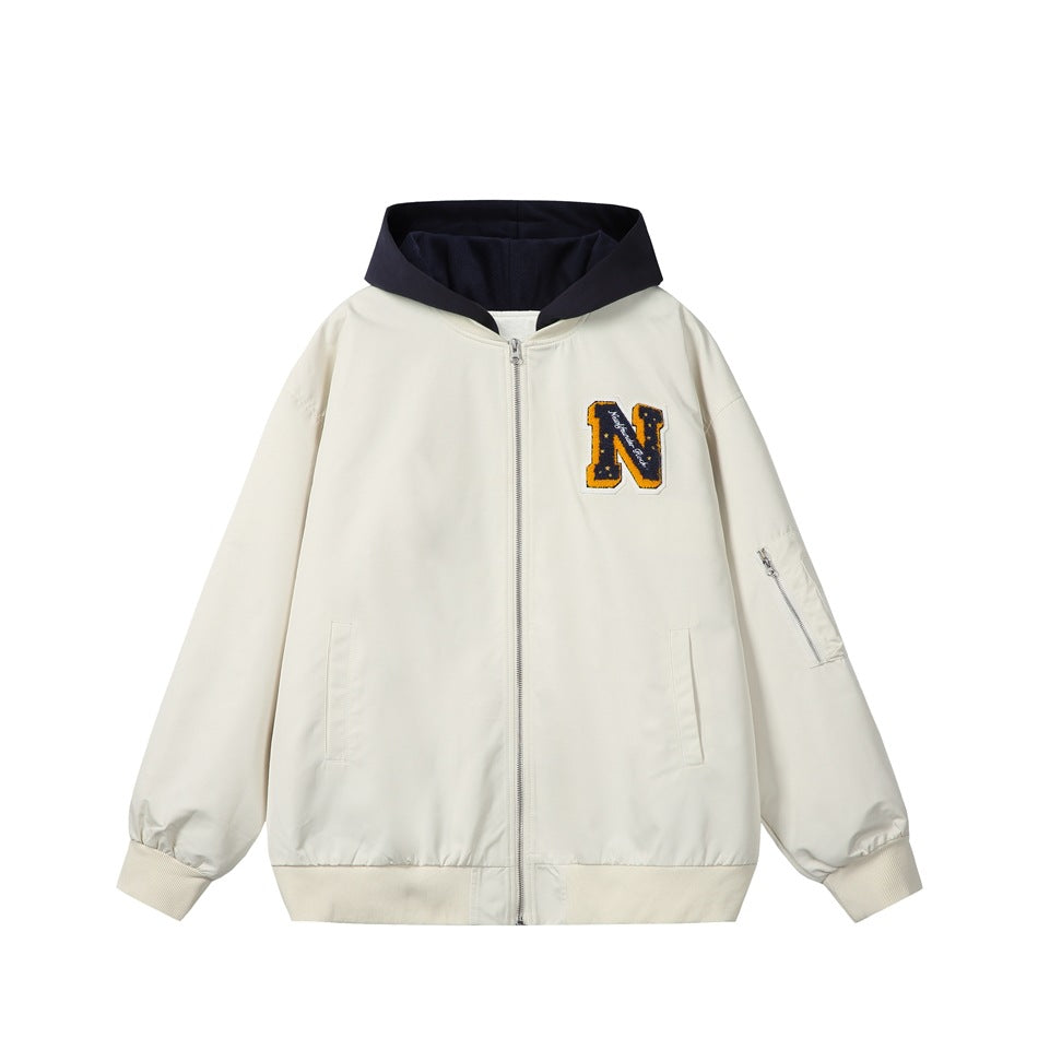 Beige zip-up hooded jacket with navy hood, chenille letter N patch, sleeve zip pocket and ribbed cuffs, front view