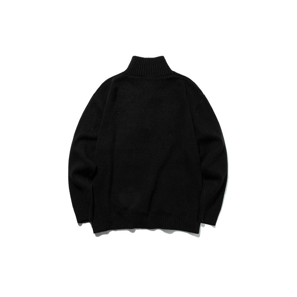 Black knit sweater back view with high ribbed collar, dropped shoulders and ribbed hem