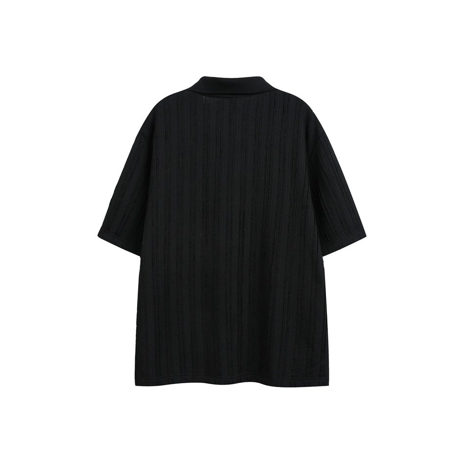 Back view of a black short-sleeve polo shirt with vertical textured stripes.