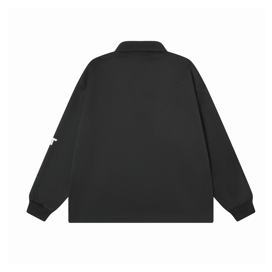 Back view of a plain black long-sleeve polo with a collar and ribbed cuffs; a small sleeve detail is visible.