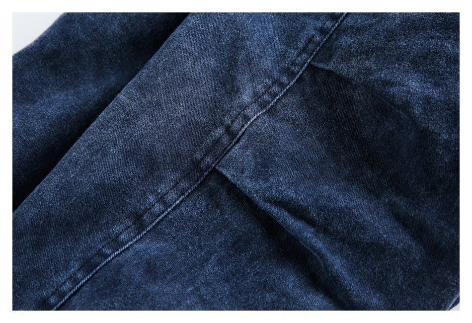 Close-up of dark blue fabric showing a diagonal stitched seam.
