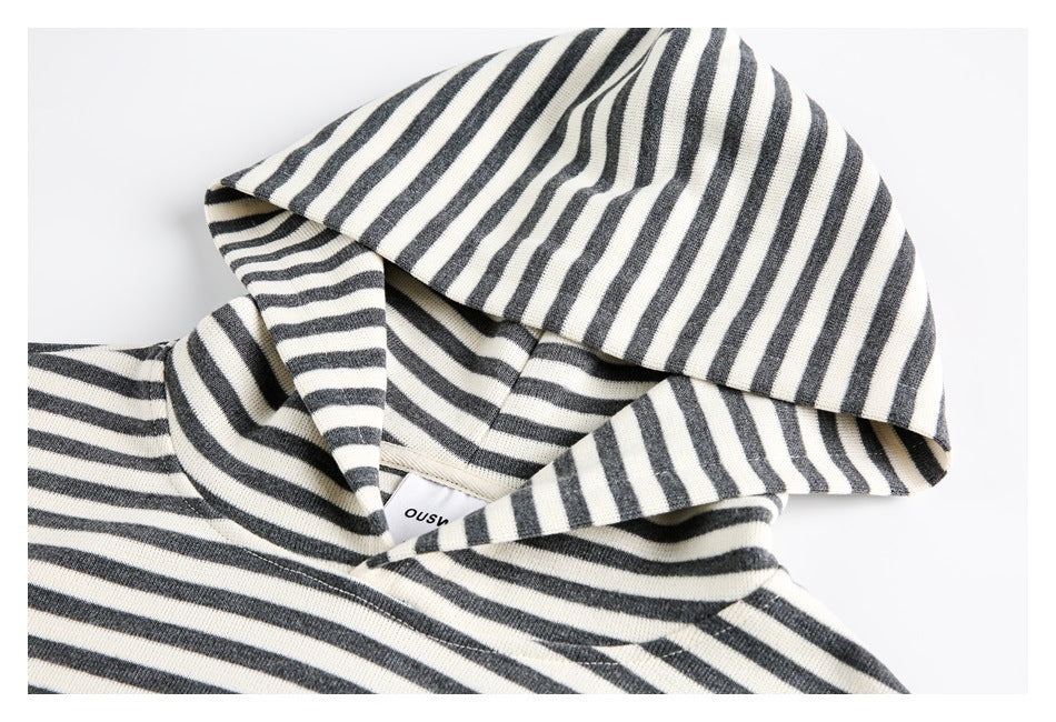 Close-up of the striped sweatshirt's hood and neckline, showing a small sewn-in label.
