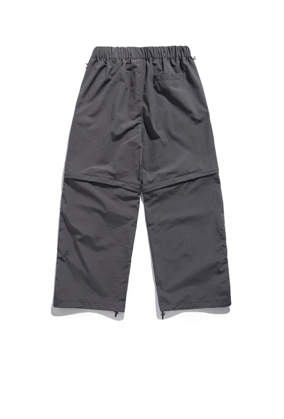 Back view of charcoal gray wide-leg pants with an elastic waistband, a rear pocket, panel seams and adjustable hems.