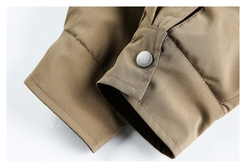 Close-up of a tan sleeve cuff with a silver snap button and neat stitching.