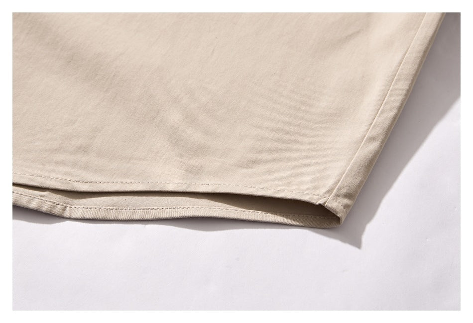 Close-up of the beige shirt's lower hem and side seam.