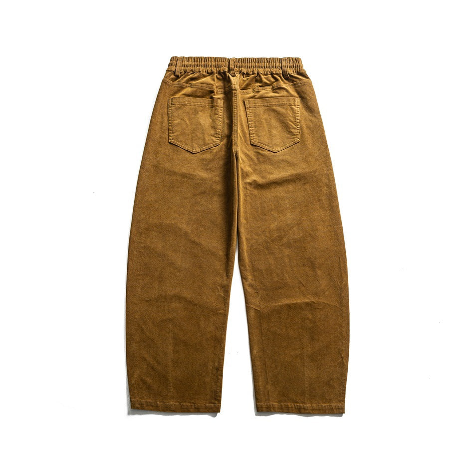 Full back view of mustard-brown pants with an elastic waistband and two rear patch pockets, laid flat on white.