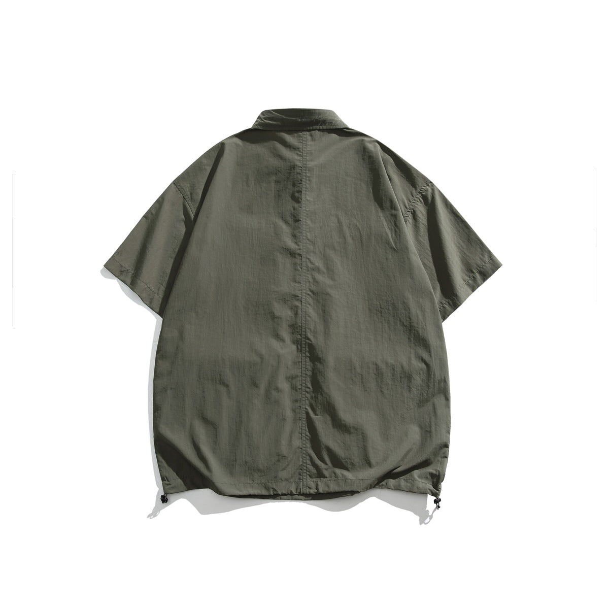 Back view of an olive-green short-sleeve collared shirt with a center seam and drawcords at the hem.