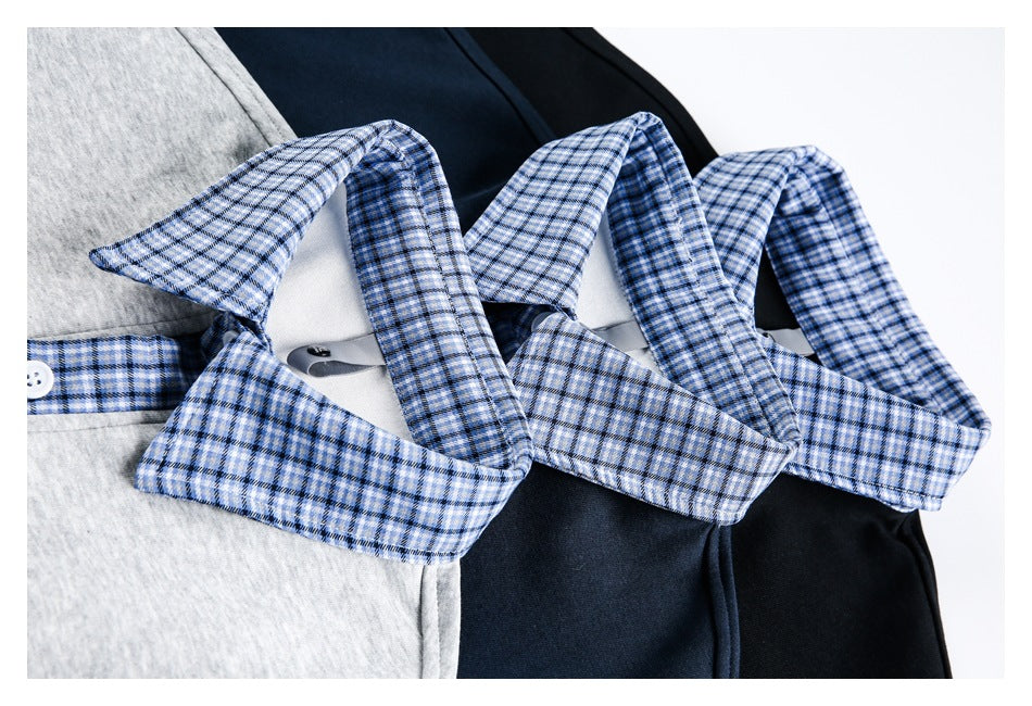 Close-up of gray, navy, and black tops showing their blue plaid collars and contrasting trim.