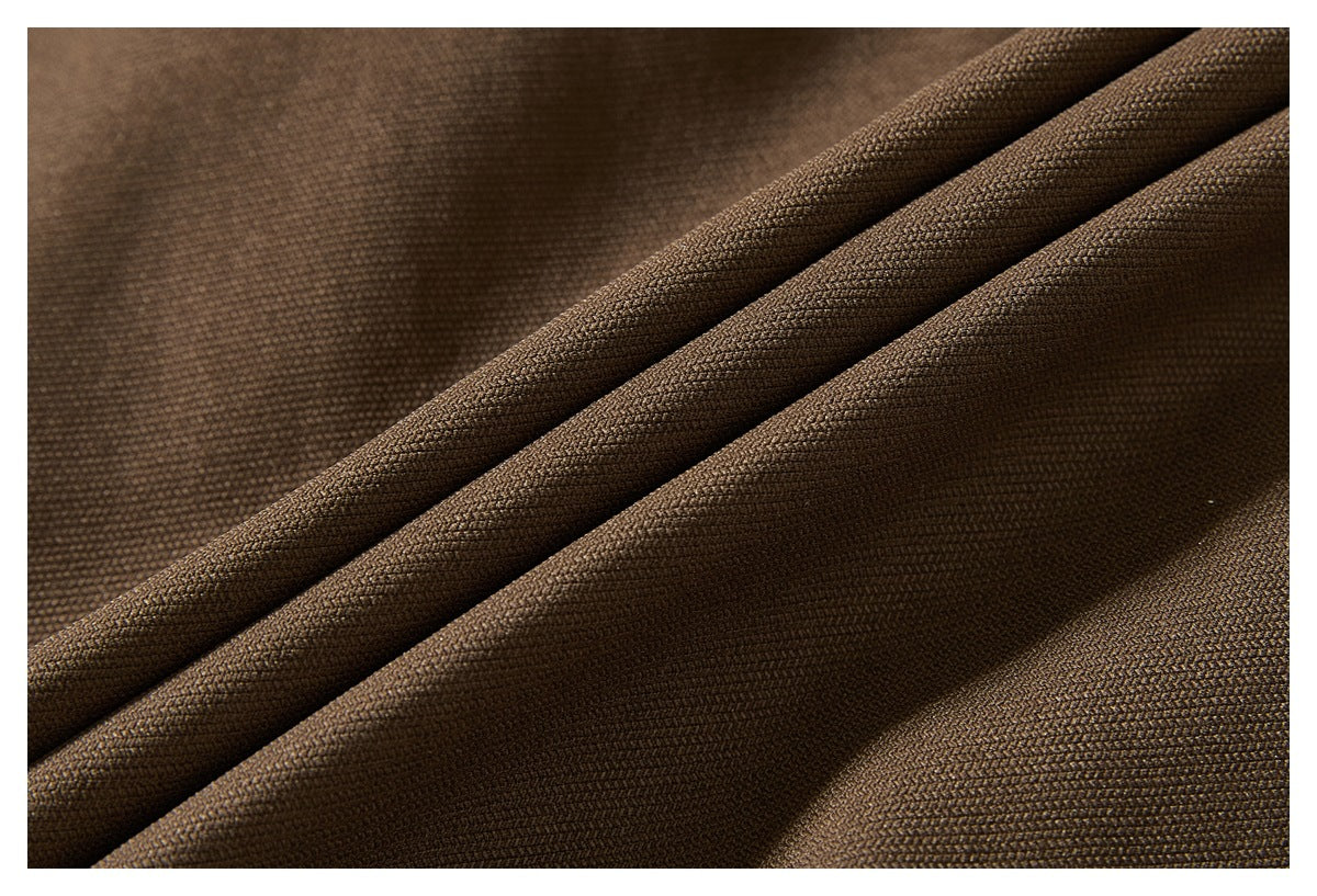 Close-up showing the woven texture and folds of brown garment fabric.