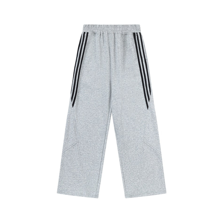 Heather gray wide-leg sweatpants with black triple side stripes, flat lay on white