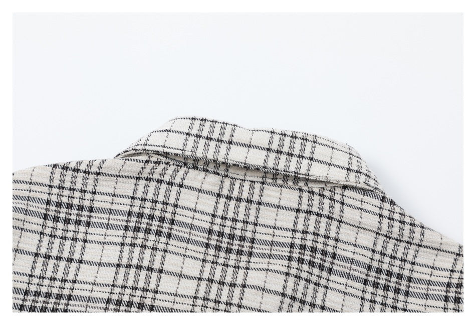 Upper back of a cream plaid shirt, showing the collar and shoulder area.