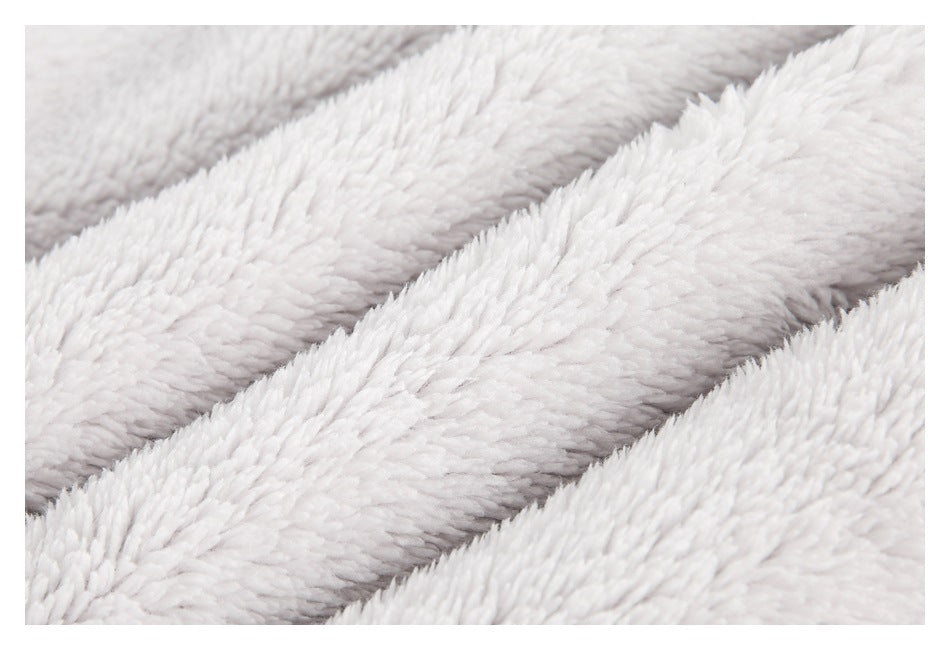 Extreme close-up showing the long, soft pile of pale gray plush fabric.