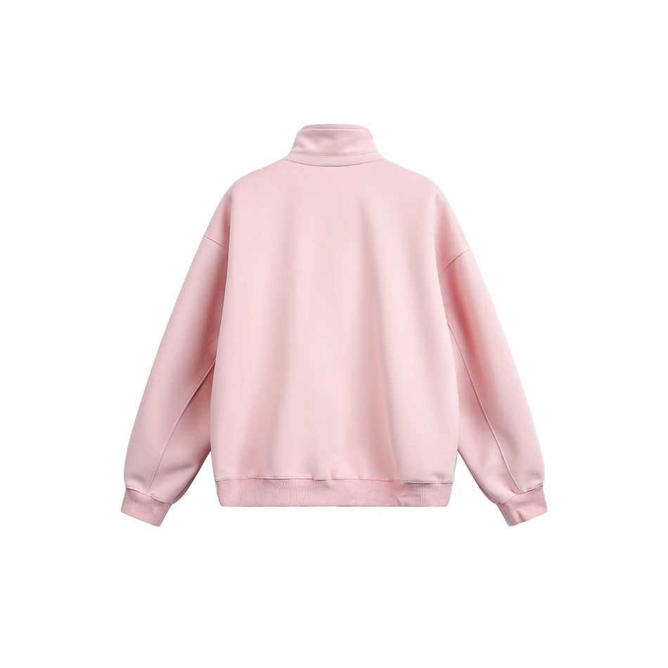 Back view of a pale pink pullover with a high collar, dropped shoulders, long sleeves, and ribbed cuffs and hem.