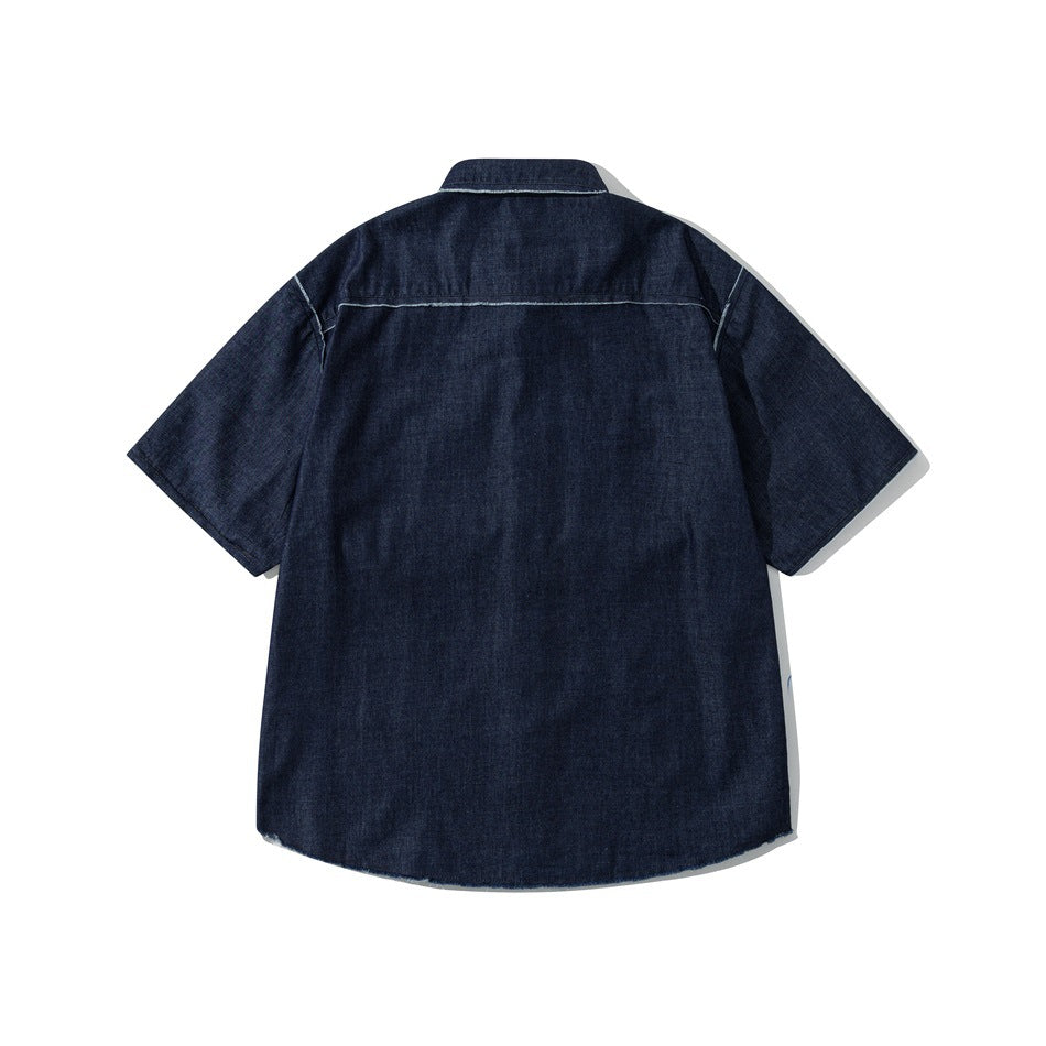 Back view of dark blue short-sleeve denim shirt with yoke seam and frayed light trim at the hem
