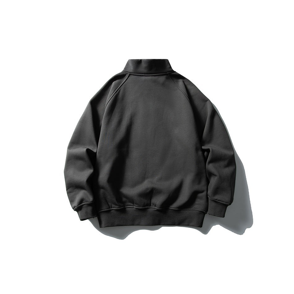 Dark gray jacket flat lay, back view with stand collar, raglan sleeves and ribbed cuffs and hem