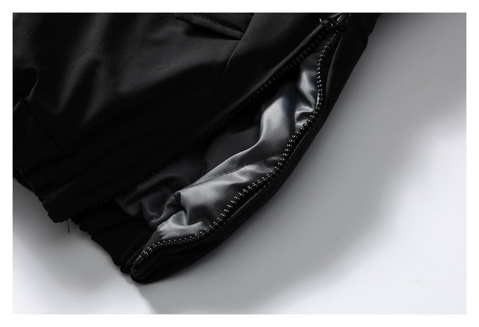 Close-up of a black jacket edge with a shiny gray lining and black zipper.