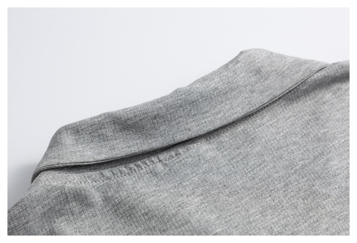 Close-up of a folded gray collar and its stitched neckline.
