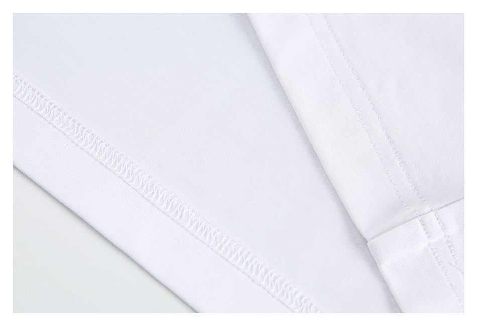 Close-up of stitching and an overlocked seam on white fabric.