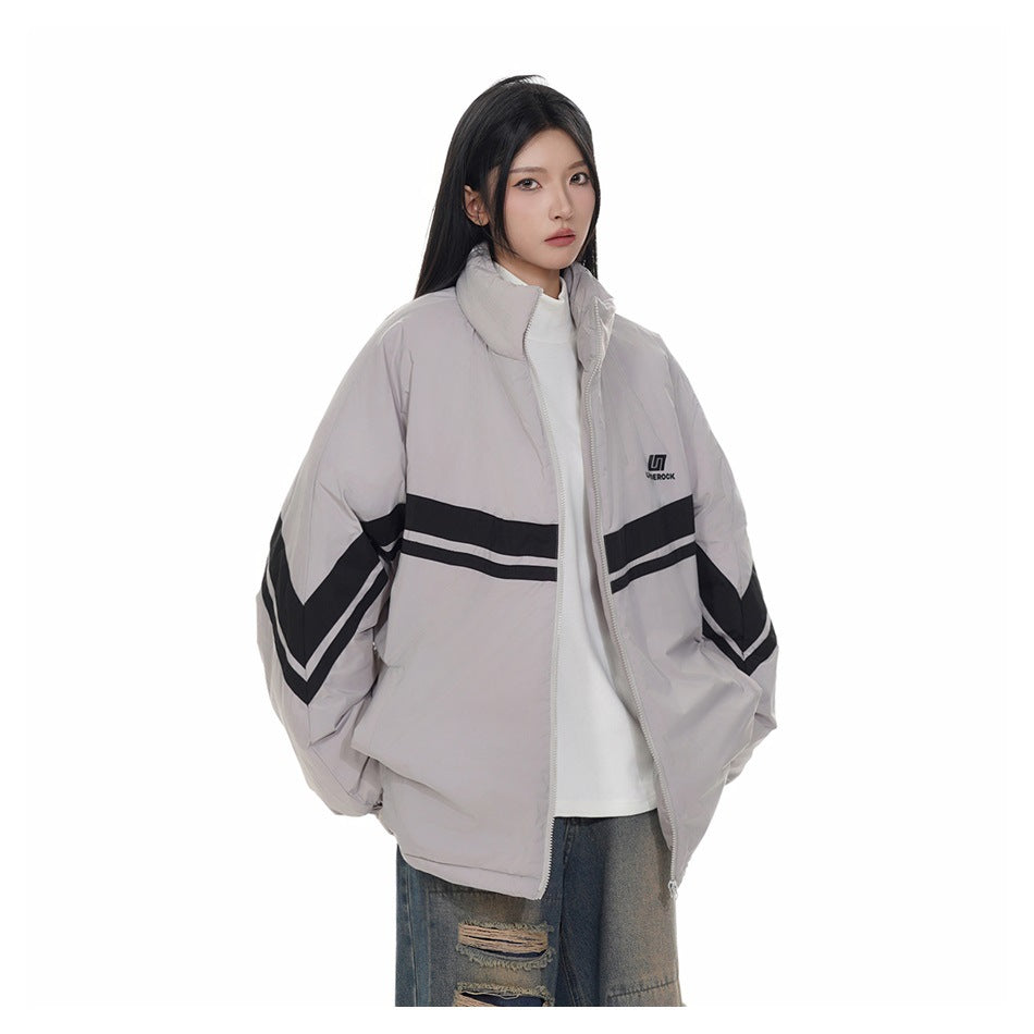 Model wearing an oversized light gray zip jacket with black-and-white stripes across the chest and sleeves.