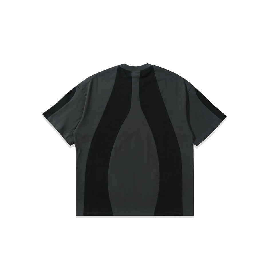 Back view of charcoal gray T-shirt with black curved panel insets and black sleeve panels, flat lay