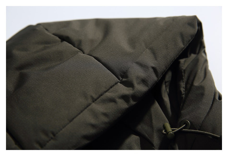 Close-up of a dark charcoal jacket hood with a seam and adjustable drawcord toggle.