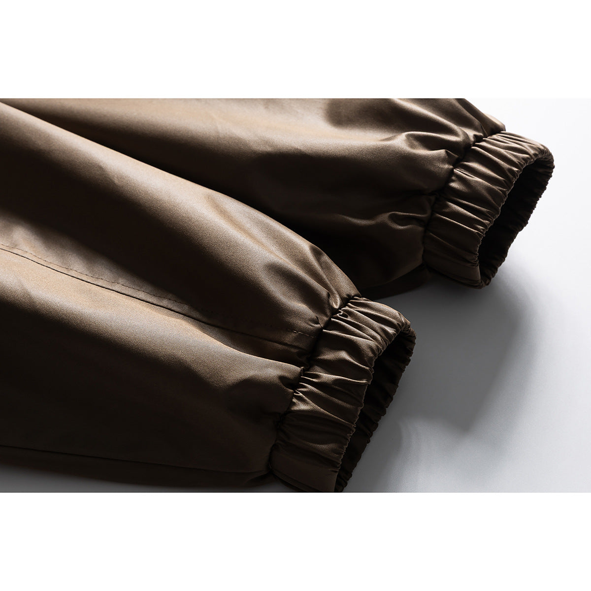 Close-up of the jacket's dark brown sleeves and gathered elastic cuffs.