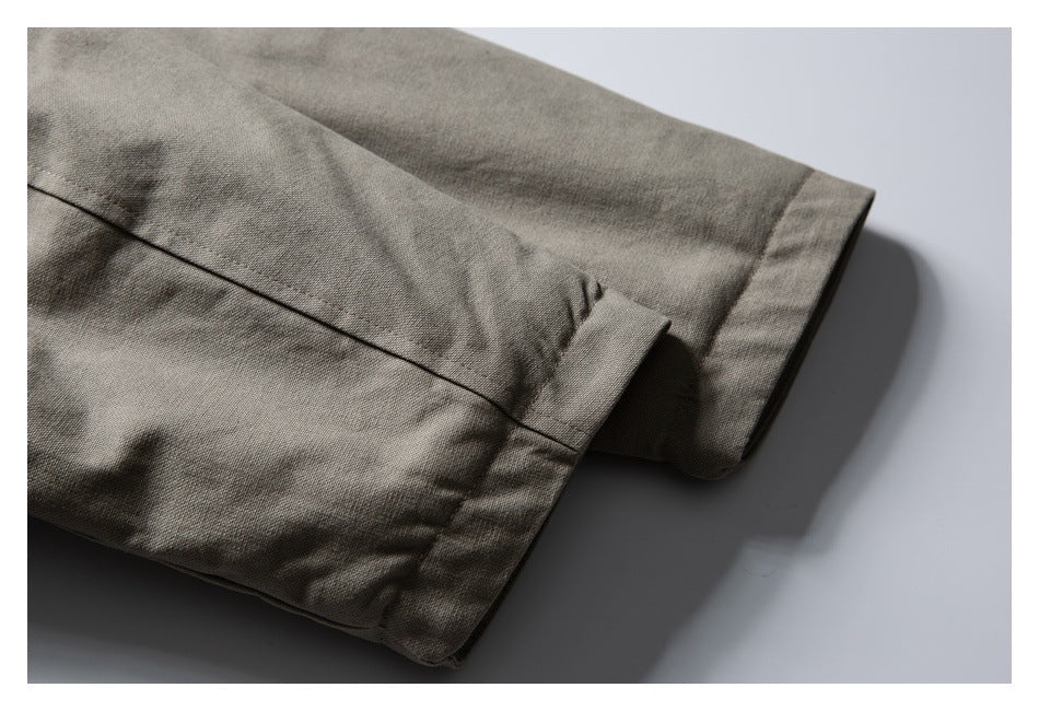 Close-up of the taupe jacket sleeve cuff and finished edge.
