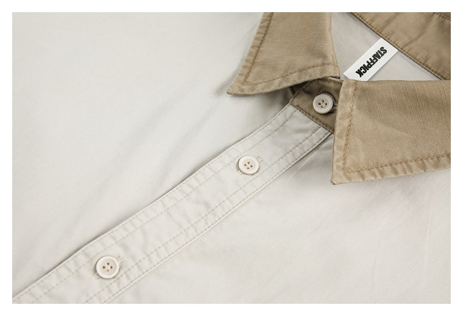Close-up of an off-white shirt's button placket and tan collar with a sewn-in neck label.