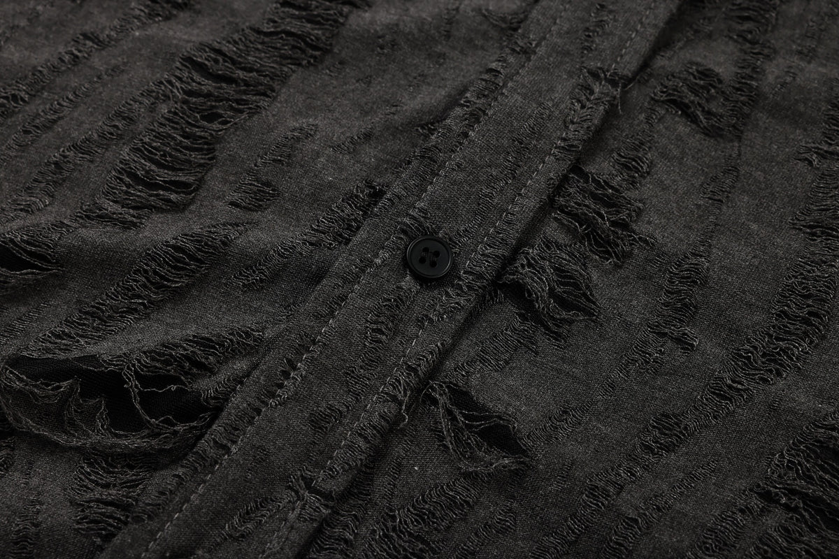 Close-up of charcoal-black garment fabric with raised frayed stripes, a stitched seam, and a black button.