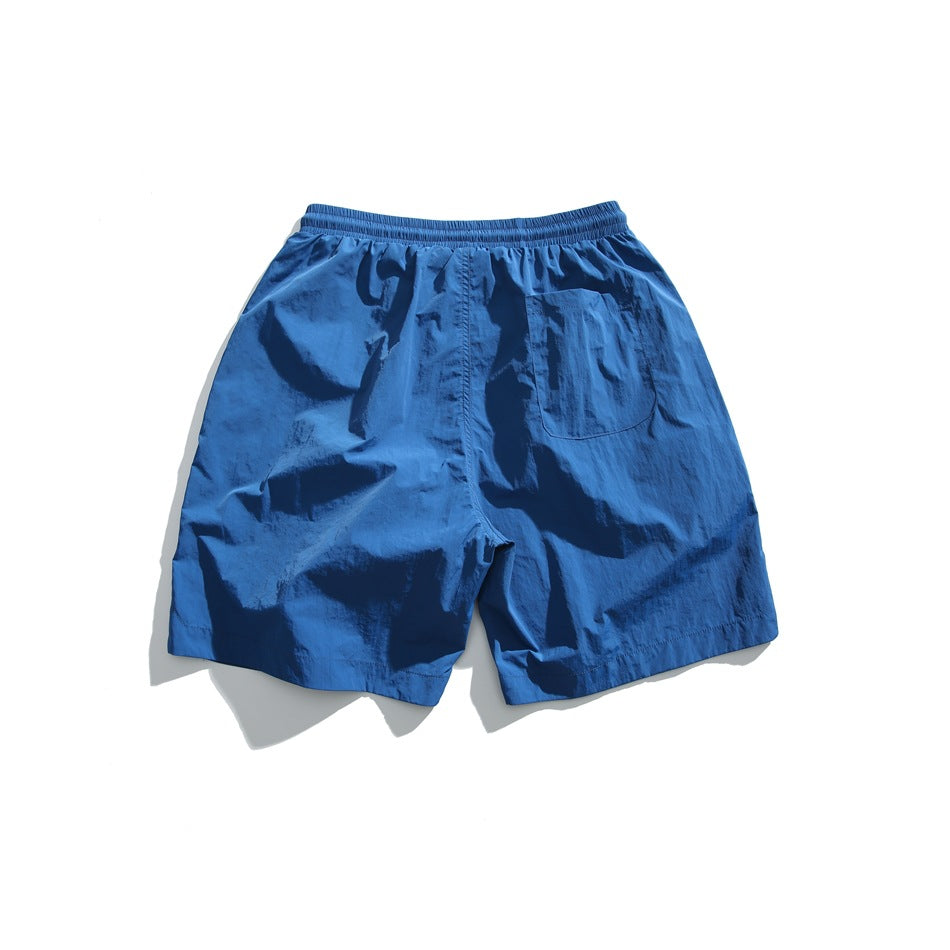 Lake blue shorts back view with elastic waistband and a patch pocket on the right back