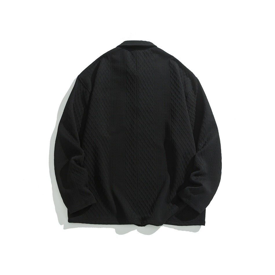 Back view of a black textured button-front jacket laid flat against a white background.