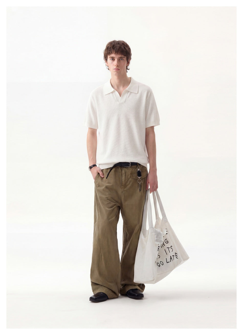 Full-length front view of a man wearing an ivory short-sleeve polo and olive trousers.