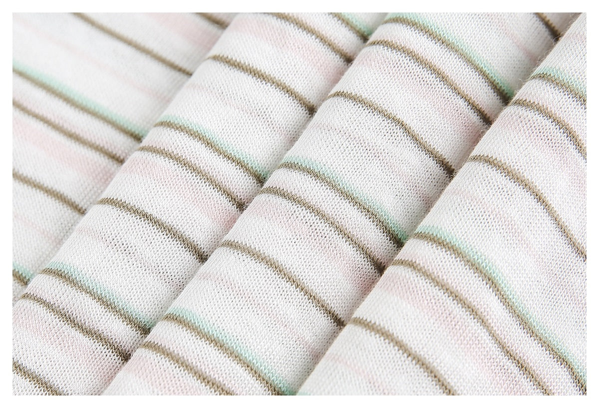 Macro view of off-white knit fabric with fine taupe, pale pink, and mint stripes and visible loops.