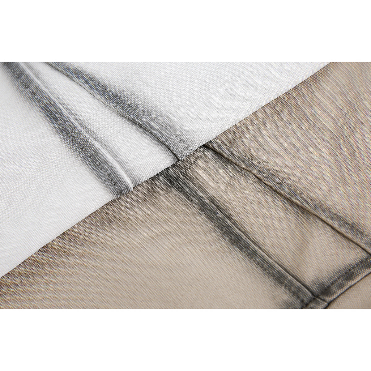Close-up of dark contrast stitching along seams where the light gray and taupe shirt panels meet.