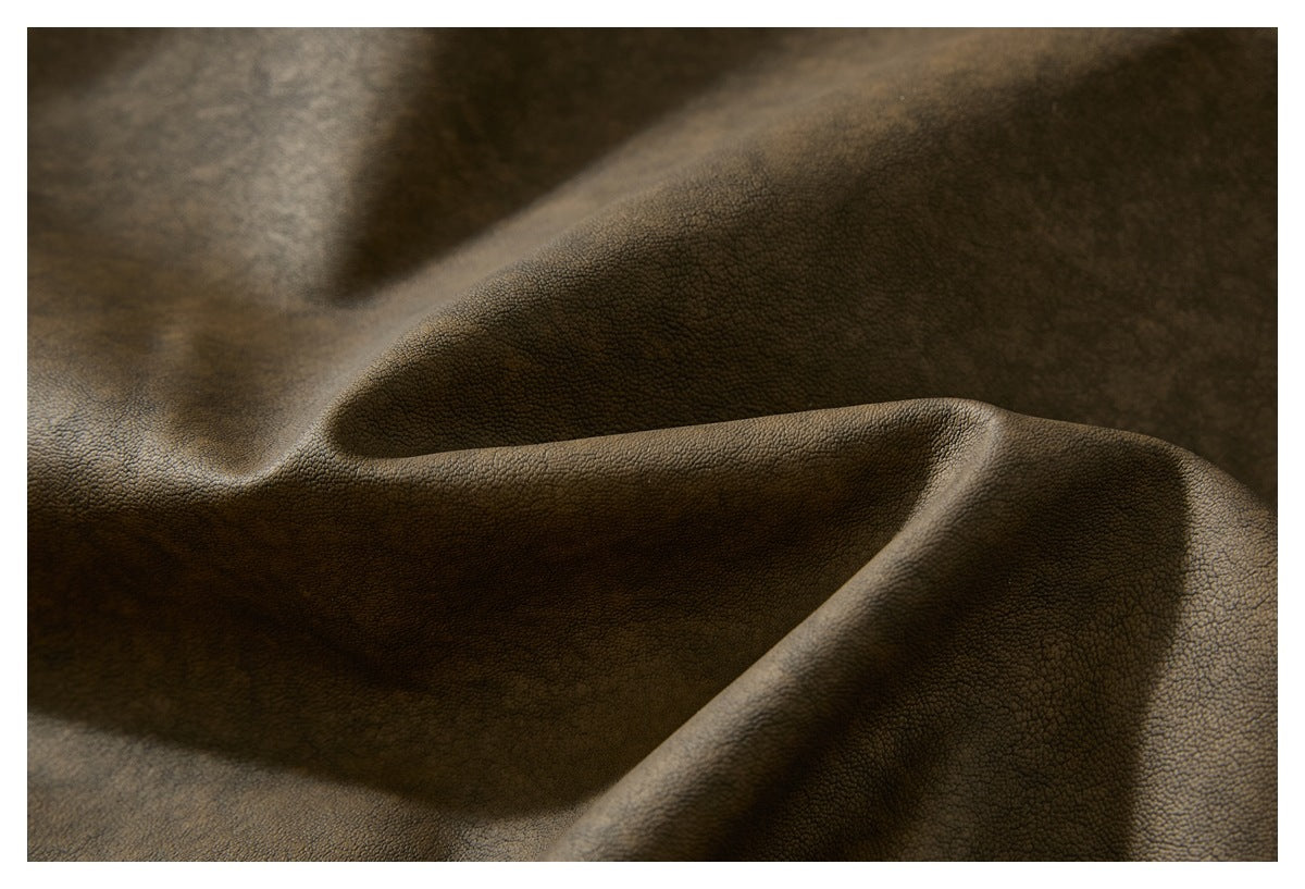 Close-up of the brown jacket material showing its pebbled surface and folds.