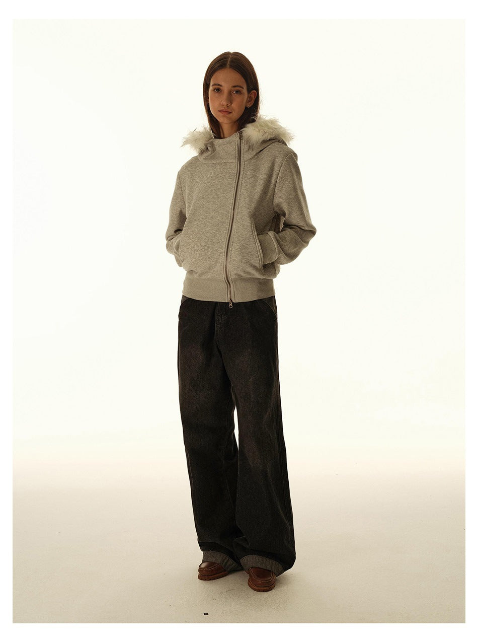 Full-length model wearing a gray zip-up hoodie with a white faux-fur-trimmed hood and wide black pants.