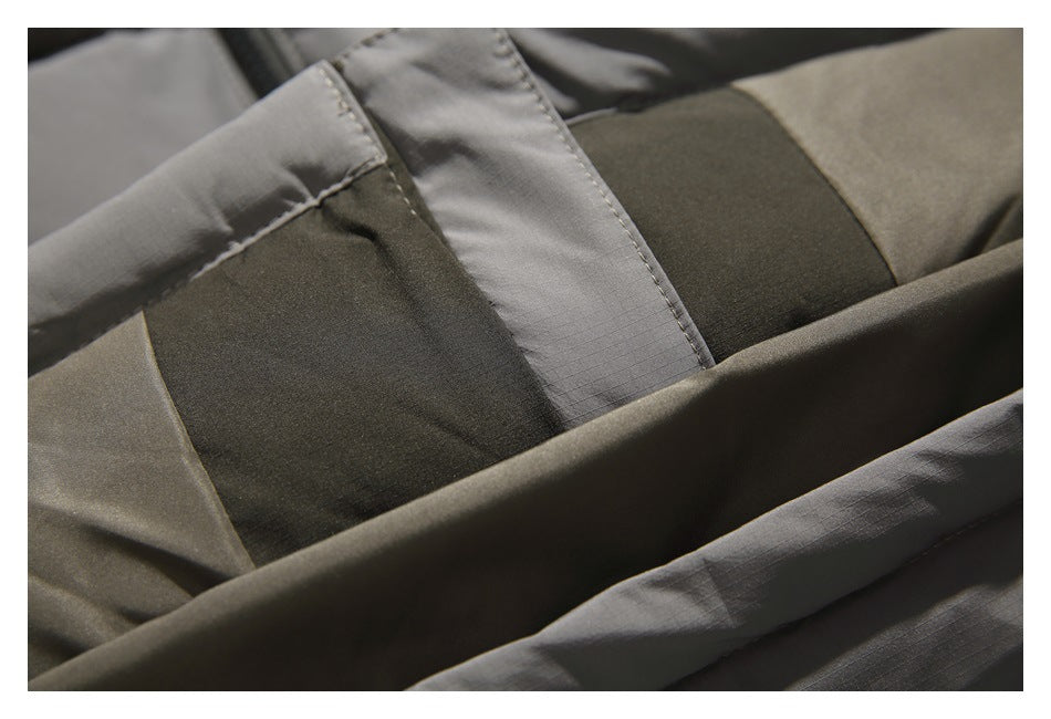 Close-up of olive and gray jacket fabric panels with visible seams and stitching.