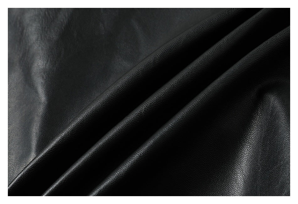 Close-up of black pebbled material folded into diagonal ridges.