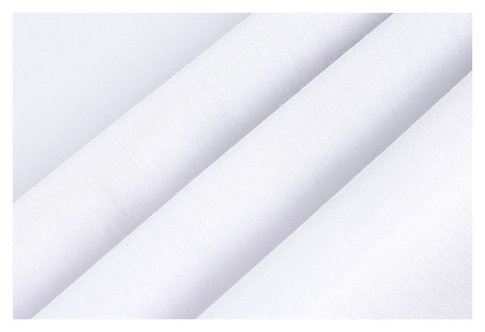Close-up of white fabric arranged in diagonal folds, showing its fine surface texture.