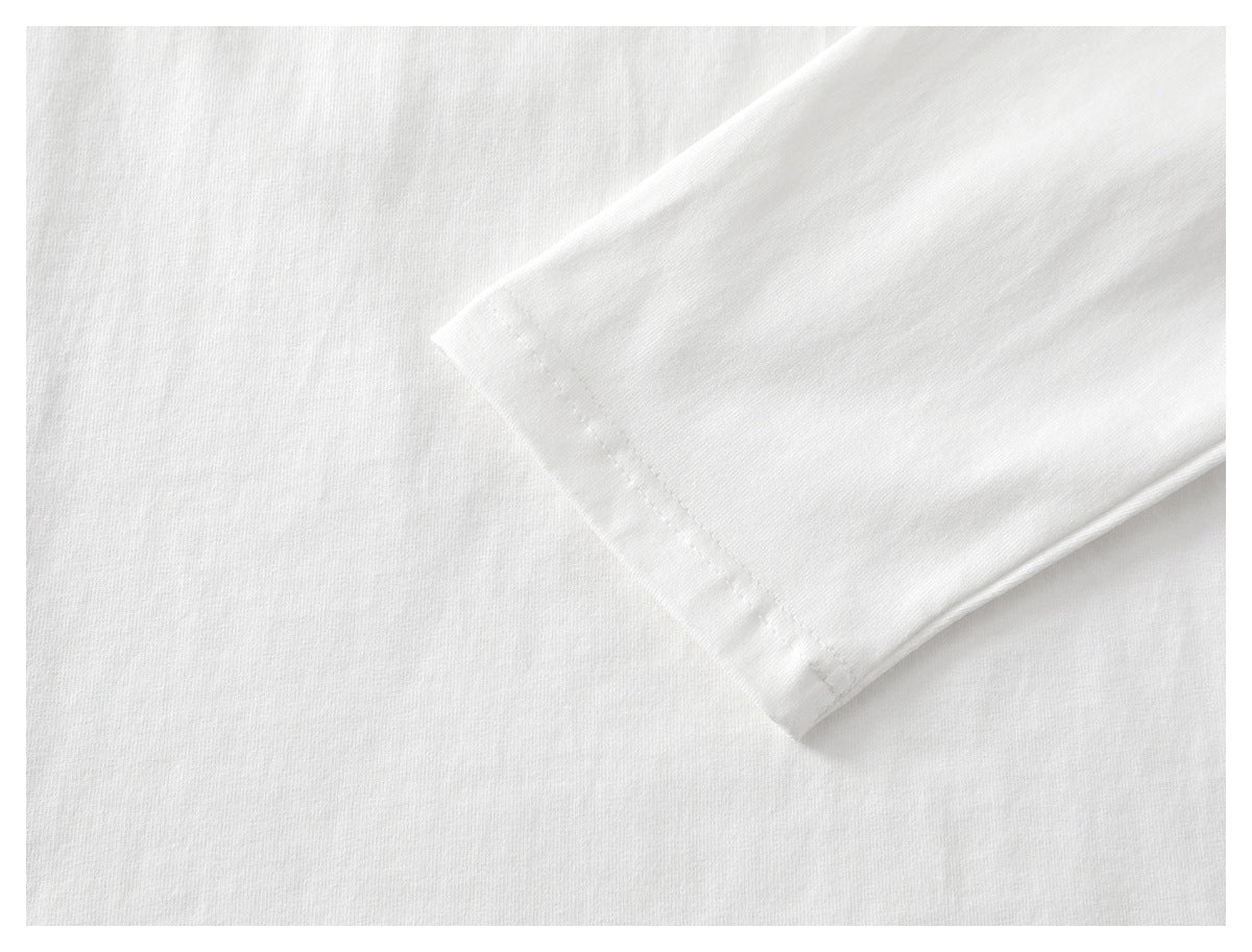 Close-up of a white shirt’s short sleeve and stitched cuff.