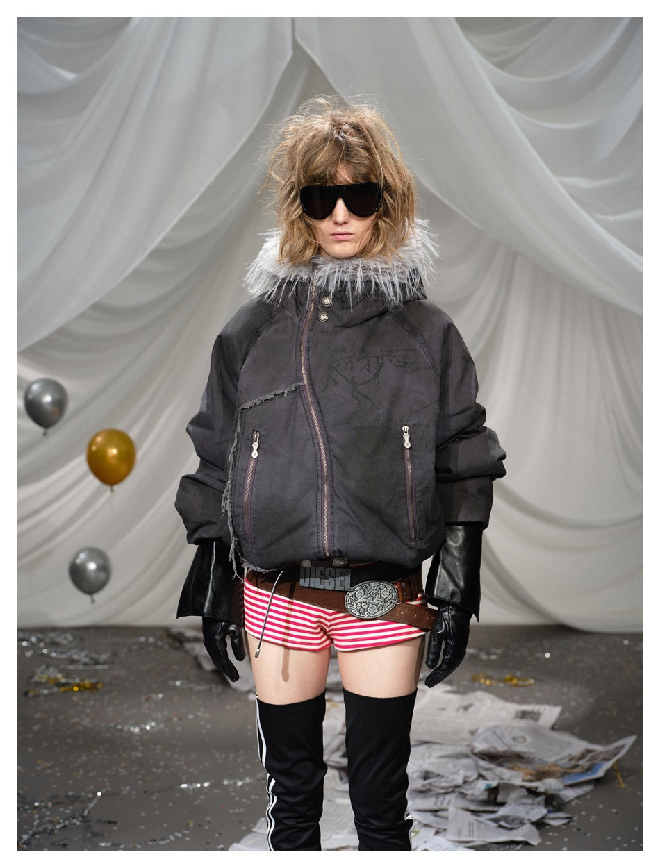 Front view of a model wearing a black padded jacket with a gray fur-trimmed hood and red-and-white striped shorts.
