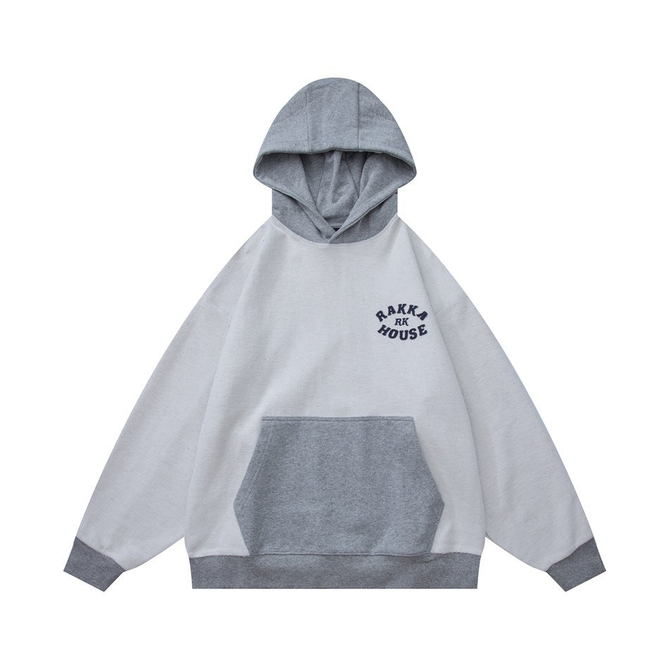 Gray and light gray colorblock hoodie with gray hood, front pocket, ribbed cuffs and navy chest graphic, flat lay front