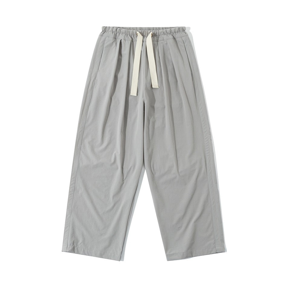 Light gray wide-leg drawstring pants with elastic waistband and front pleats, flat front view
