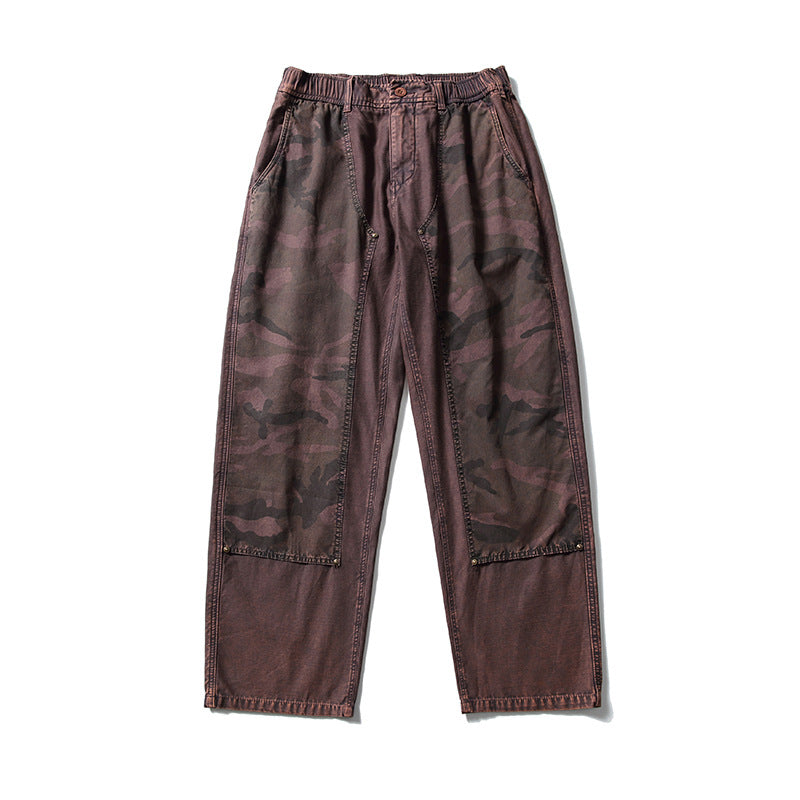 Rust brown washed wide-leg pants with camouflage front leg panels and an elastic waistband, flat lay