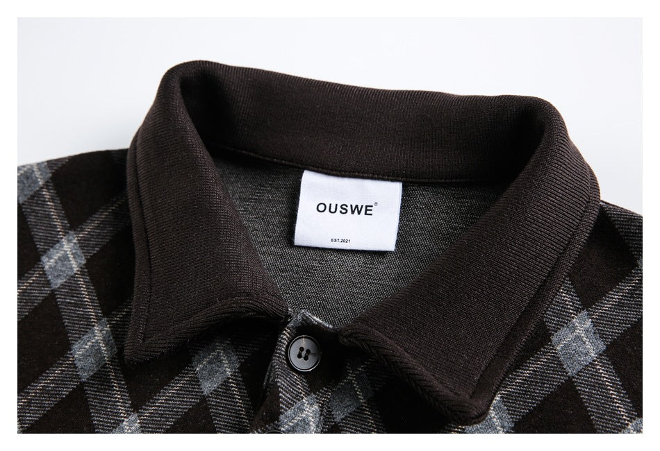 Close-up of a black plaid jacket collar, button, and sewn-in neck label.